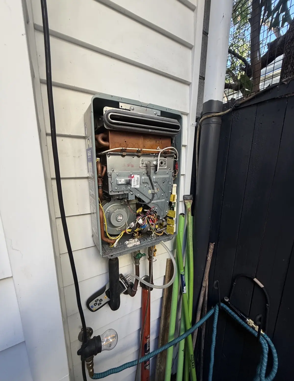 Rinnai continuous flow gas hot water system opened for servicing by a Brisbane gas fitter
