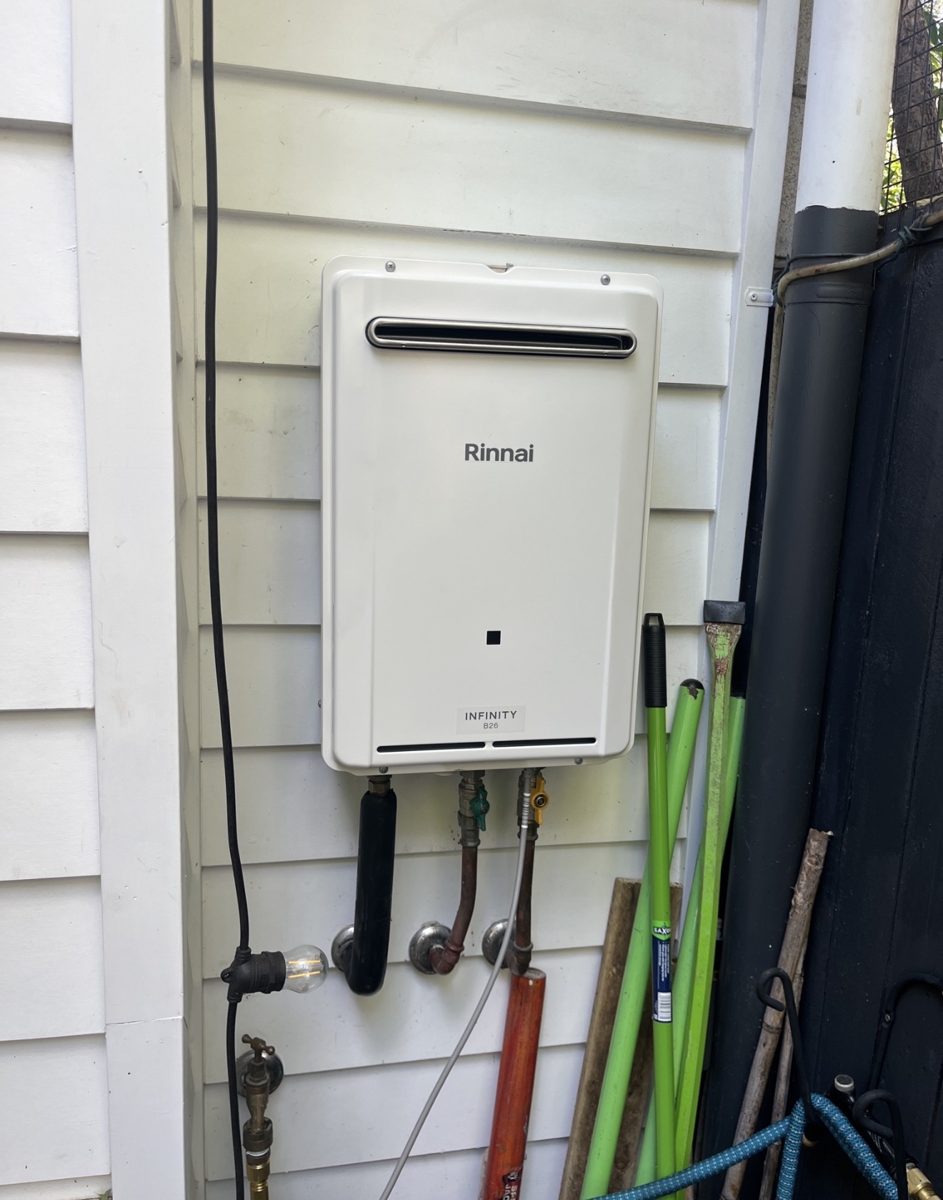 Rinnai Infinity continuous-flow gas hot water system mounted on the weatherboard wall of a Brisbane home